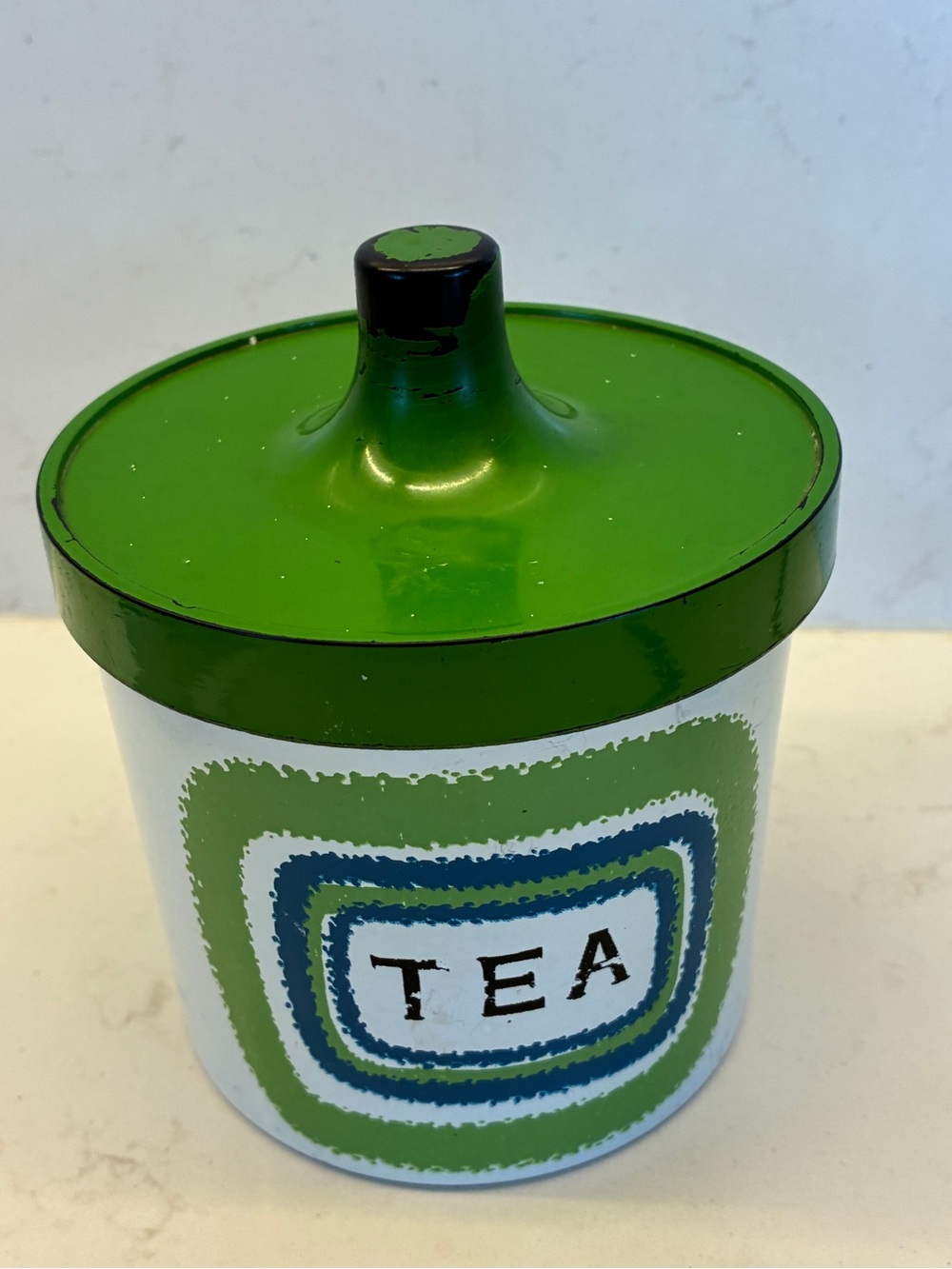 Vintage mid-century modern lacquered kitchen canister used for storing tea.